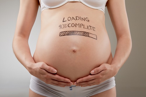 Pregnant belly with sign